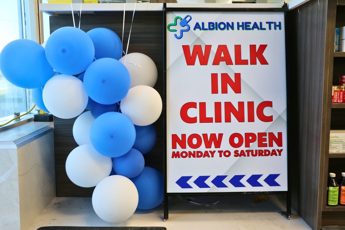 Walk-In Clinic Now Open signage at the Albion Health entrance
